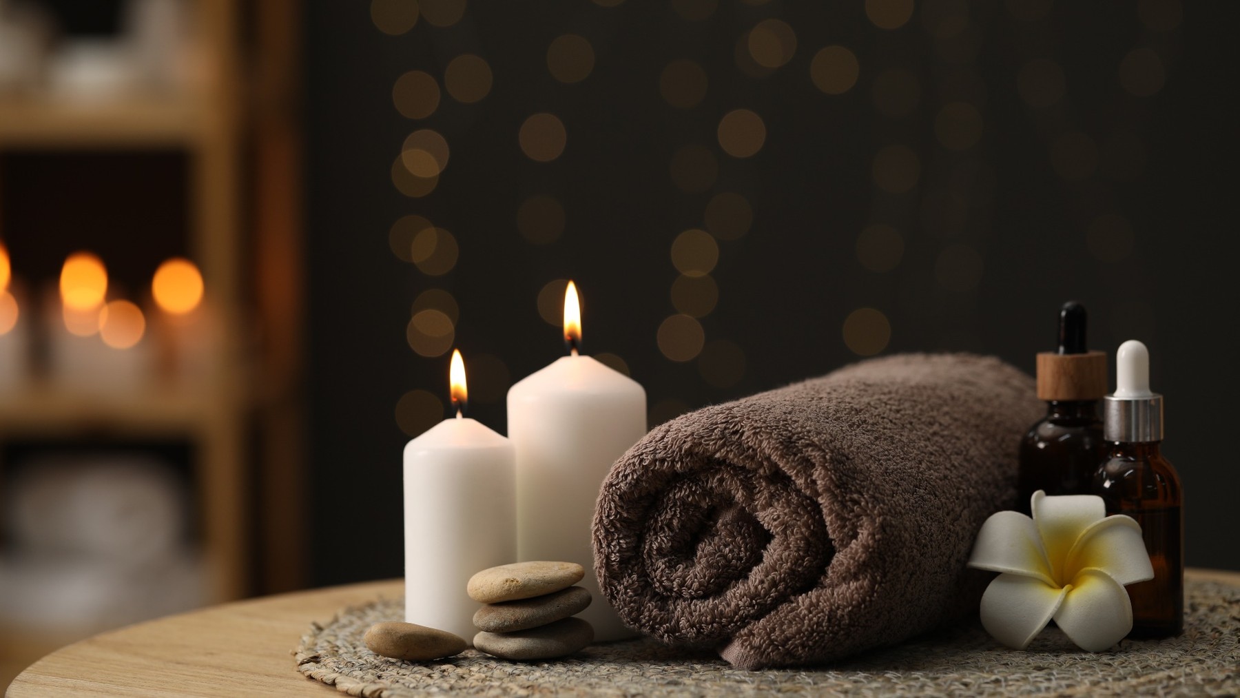 Spa products with towels, candles and care oils for treatment and retail